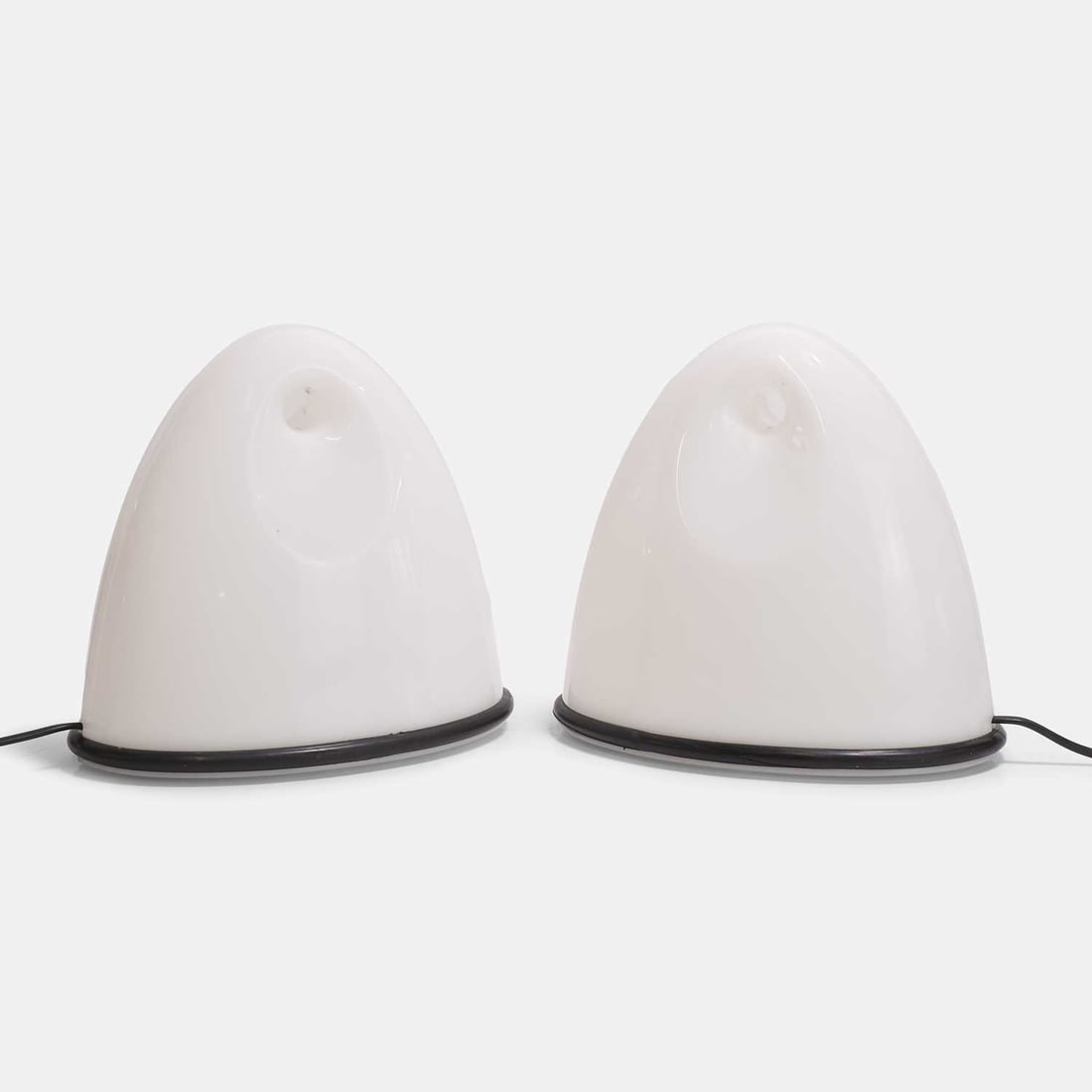 Bruno Gecchelin (Italian, b.1939) for iGuzzini, a pair of 'Lalea' table lamps,: Bruno Gecchelin (Italian, b.1939) for iGuzzini, a pair of 'Lalea' table lamps, originally designed in 1970, each pierced and rounded white acrylic shade bordered by a black rubber bumper, both inscrib