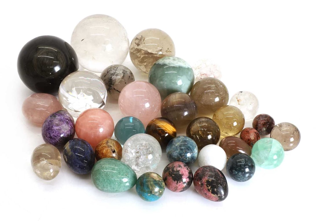 A collection of semi precious polished stone spheres: A collection of semi precious polished stone spheres to include moonstone, tiger's eye and lepidolite largest approx 9cm wide 32