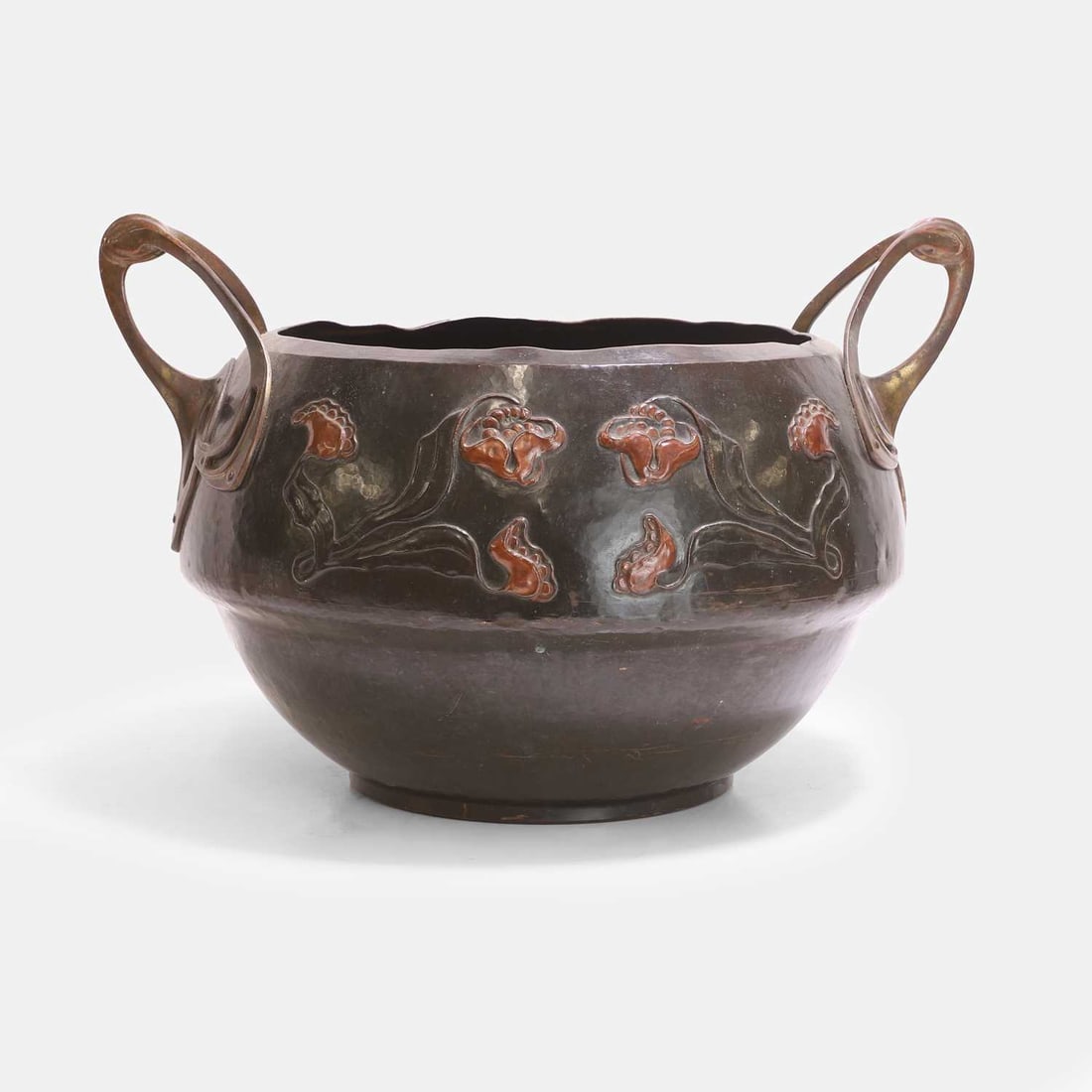 Jugendstil, a copper jardinière,: Jugendstil, a copper jardinière, circa 1910, of twin-handled form, decorated with floral motifs 52cm wide, 43cm deep, 34cm high