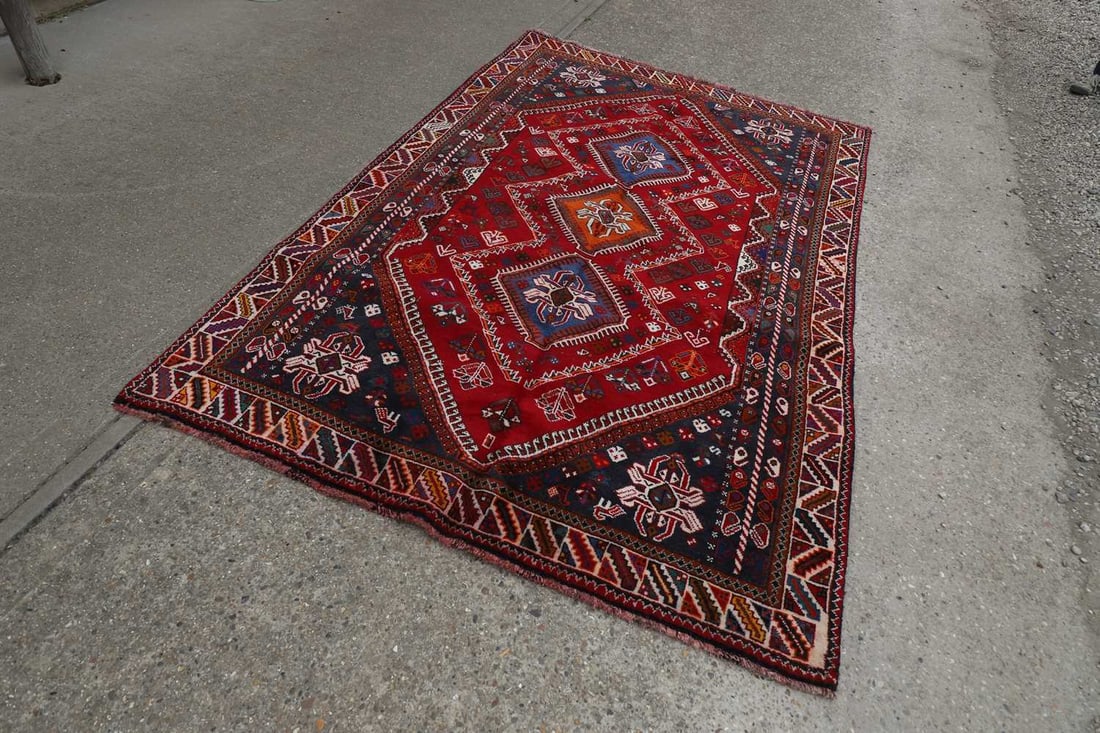 A South West Persian Qashgai carpet,: A South West Persian Qashgai carpet, the red ground with blue and orange medallions, with geometric border 260 x 168cm Condition Report: thick tuft and dense feel