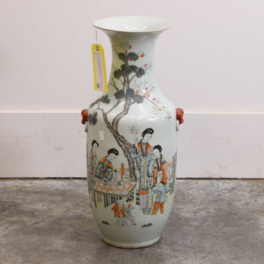 A Chinese qianjiang-enamelled vase, early 20th century,: A Chinese qianjiang-enamelled vase, early 20th century, of ovoid form with a flared mouth, flanked by twin handles in the form of mythical beasts, painted with ladies in a garden, the reverse