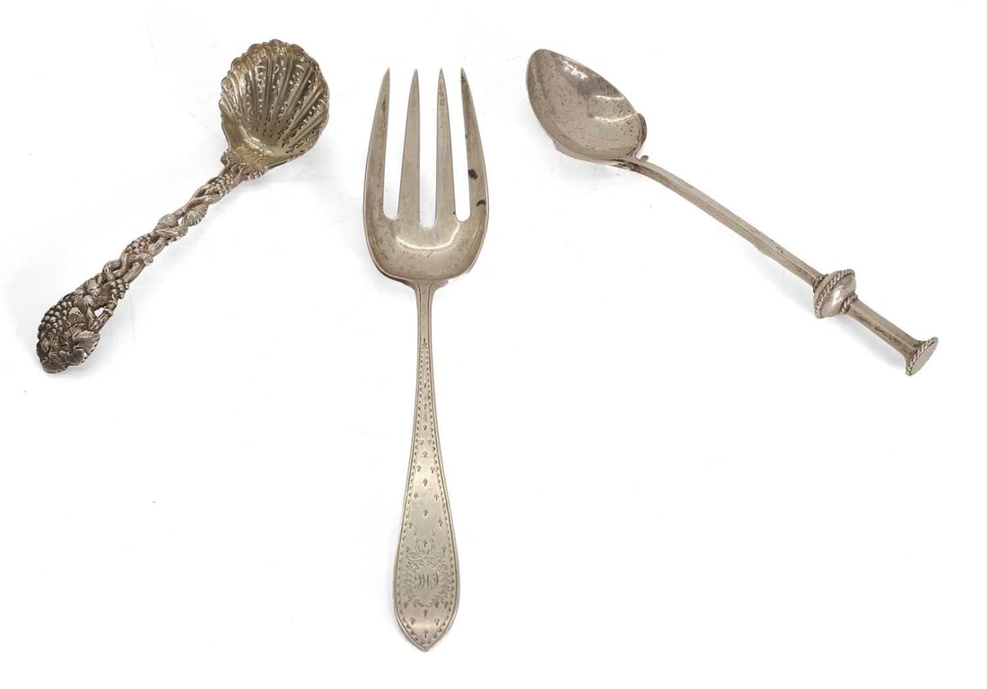 A group of silver utensils,: A group of silver utensils, an Art Nouveau style spoon by G Payne & Son, Birmingham, 1924, a serving fork by Arthur A Everts, stamped Sterling, with bright cut work throughout, the handle with ini