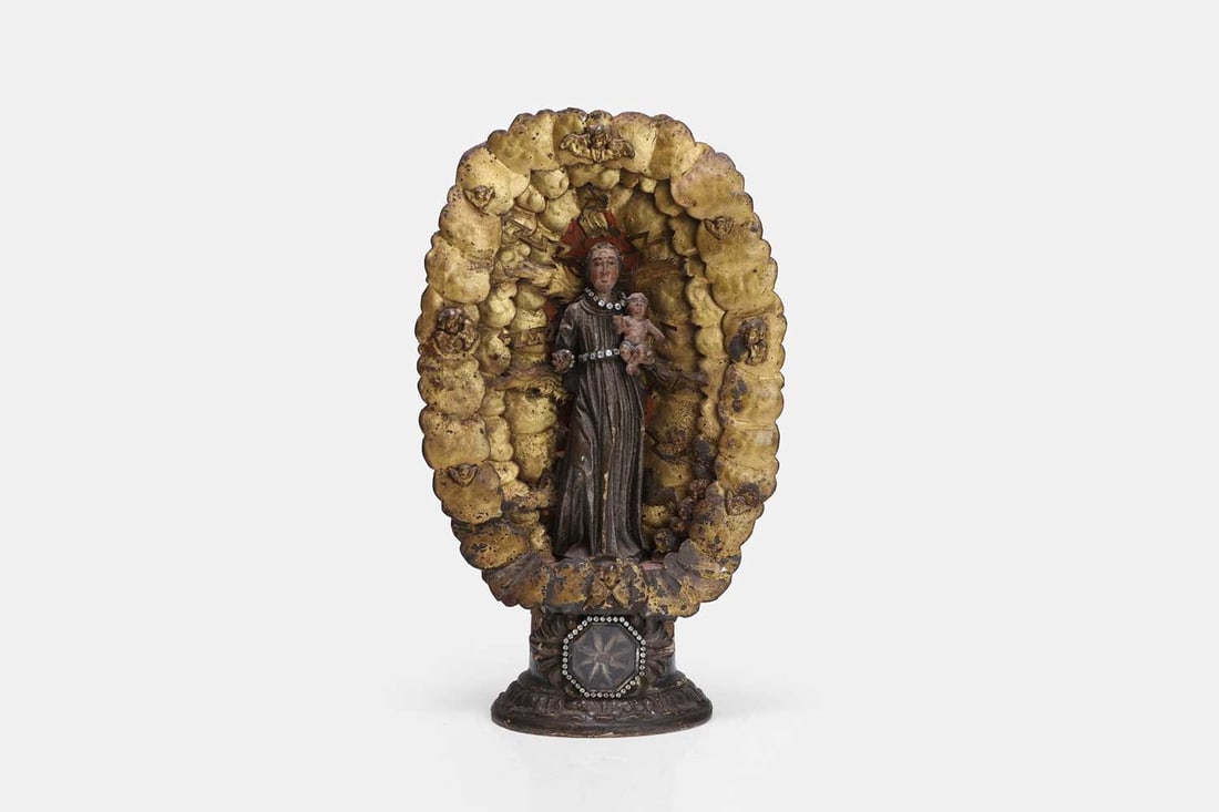 A polychrome figure of the Madonna and Child, 18th century and later, Continental,: A polychrome figure of the Madonna and Child, 18th century and later, Continental, the carved wooden and painted figure decorated in faux gemstones, enclosed within a gilded embossed frame depicting