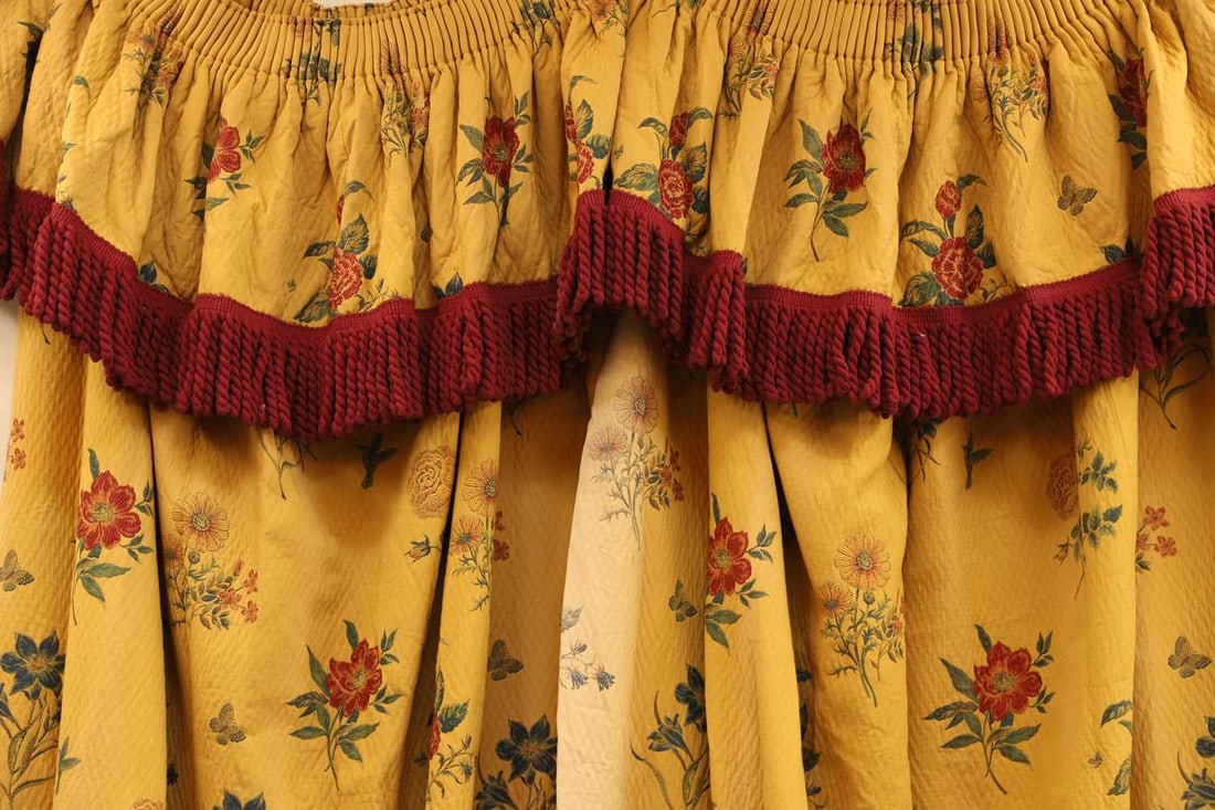 A pair of mustard and floral embroidered curtains with a pelmet, 20th century, - 2