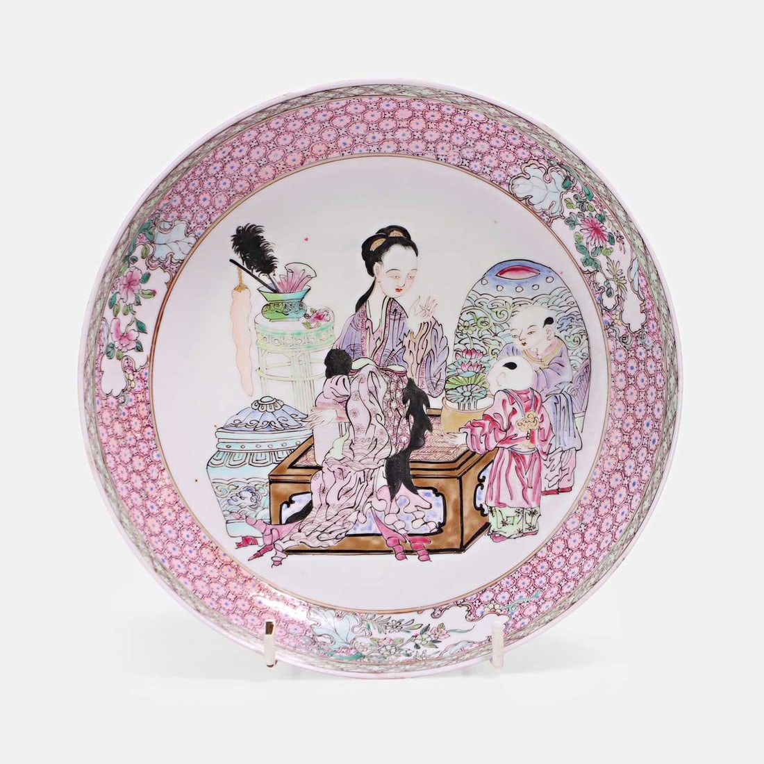 A famille rose ruby back plate, 18th century,: A famille rose ruby back plate, 18th century, restored, the central field depicted a lady with children 20.2cm diameter Condition Report: Restored
