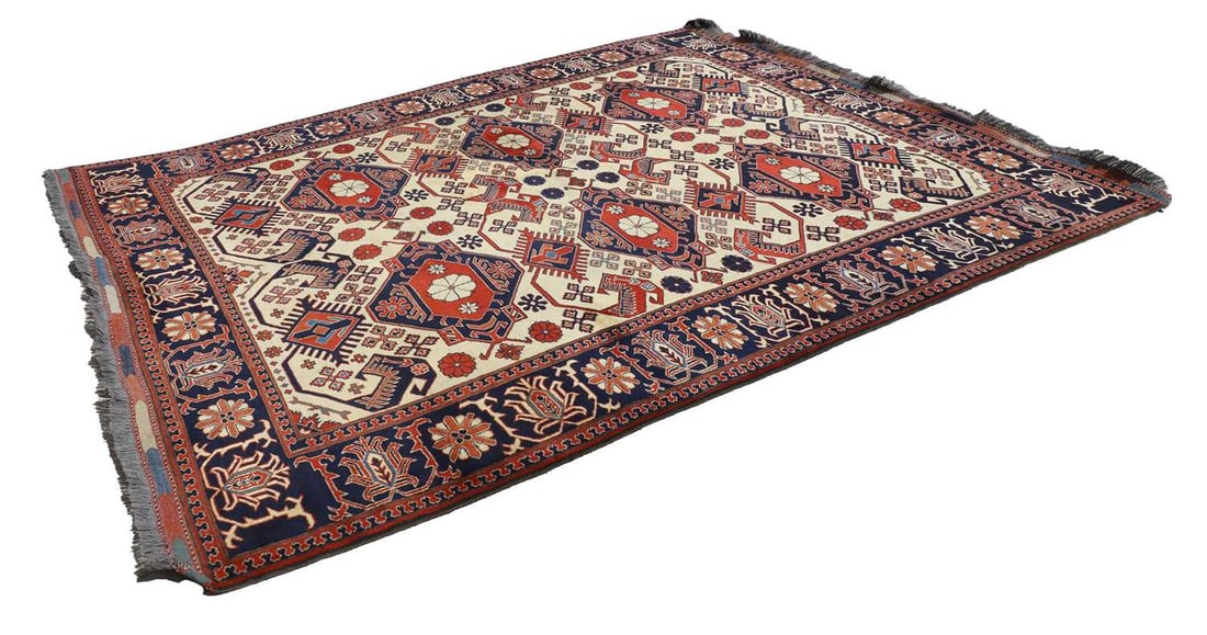 A Turkish wool rug,: A Turkish wool rug, of red ground, with blue wrap around border, encapsulating a cream ground centre under six repeating medallions 257cm wide 334cm long