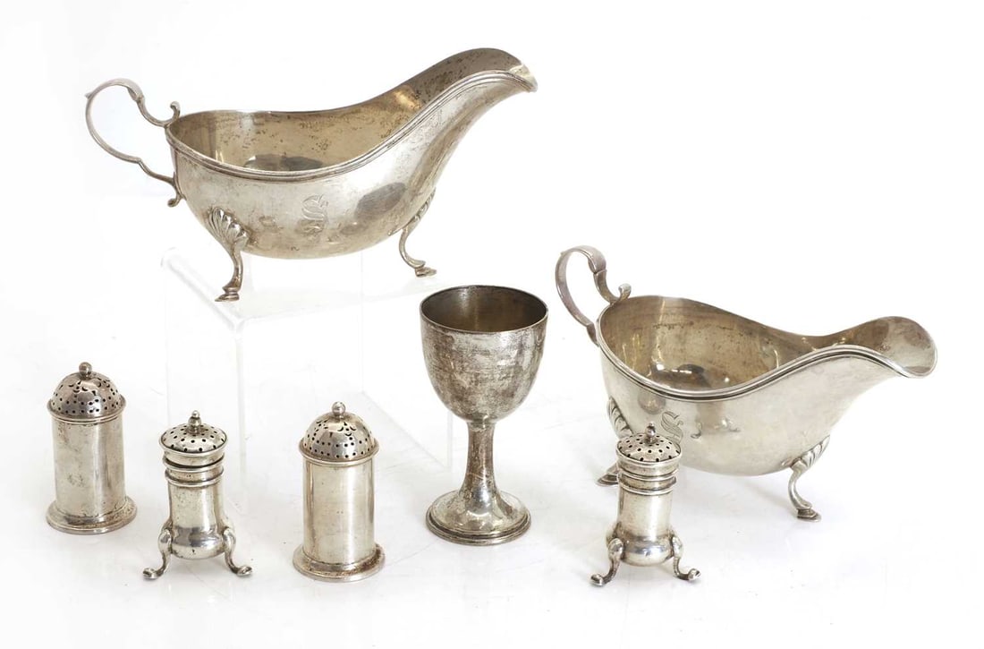 A pair of silver sauceboats,: A pair of silver sauceboats, with hooved cabriole supports, engraved 'S' to one side, with double rolled edge, marked 'Birks sterling' to underside, together with two pairs of pepperettes, and an egg