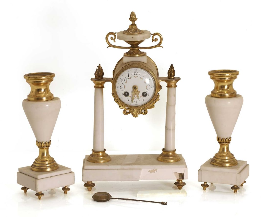 A gilt and marble clock garniture, late 19th century,: A gilt and marble clock garniture, late 19th century, with a painted enamel dial, with Arabic numerals, with a French twin fusee movement striking the half-hours, with a pendulum, and a pair of garnit