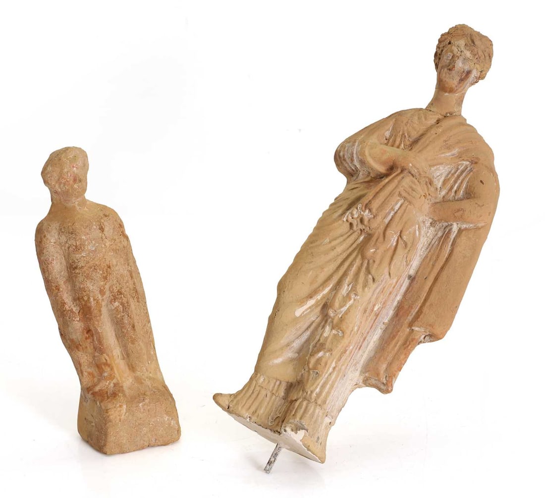 Two terracotta figures, probably 2nd century BCE,: Two terracotta figures, probably 2nd century BCE, comprising a Hellenistic Greek terracotta figure, modelled as a woman standing in flowing drapery with layered robes and mantle, verso with rectangula