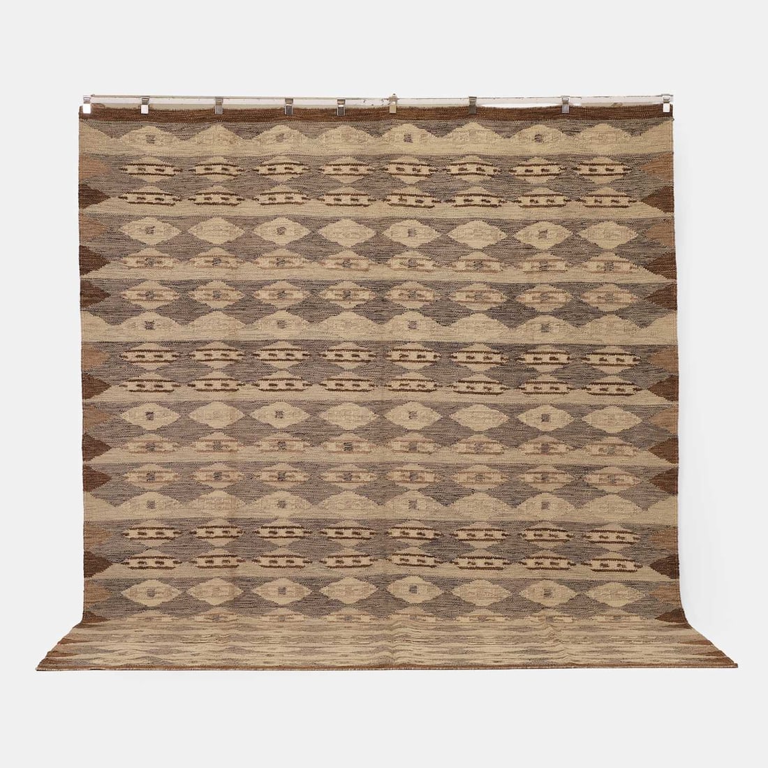 A Scandinavian-style flat-weave kilim, of recent manufacture,: A Scandinavian-style flat-weave kilim, of recent manufacture, woven with repeating geometric motifs in tones of blue, grey and brown 359 x 284cm