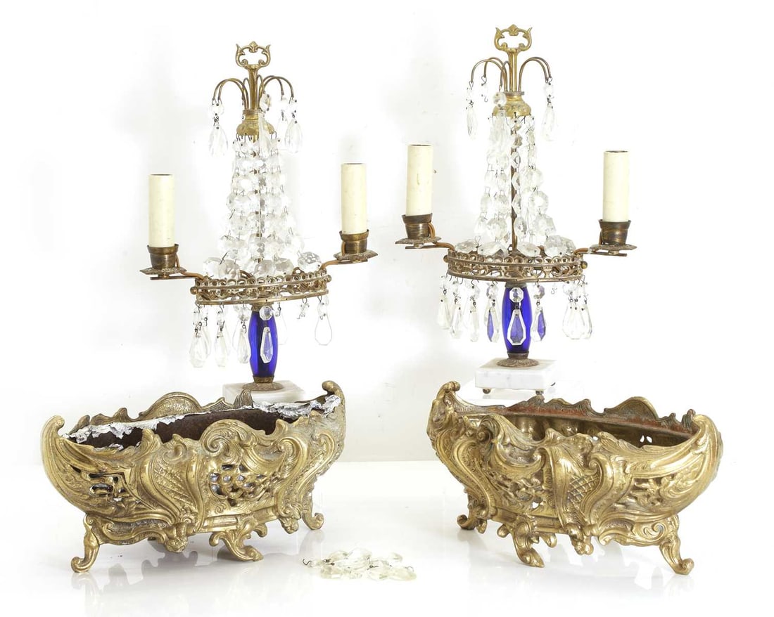 A pair of twin branch table lustres, 20th century,: A pair of twin branch table lustres, 20th century, with glass drops, brass mounts, with a blue glass column, on marble plinths, and a pair of cast planters, 20th century, one with a liner lustres,