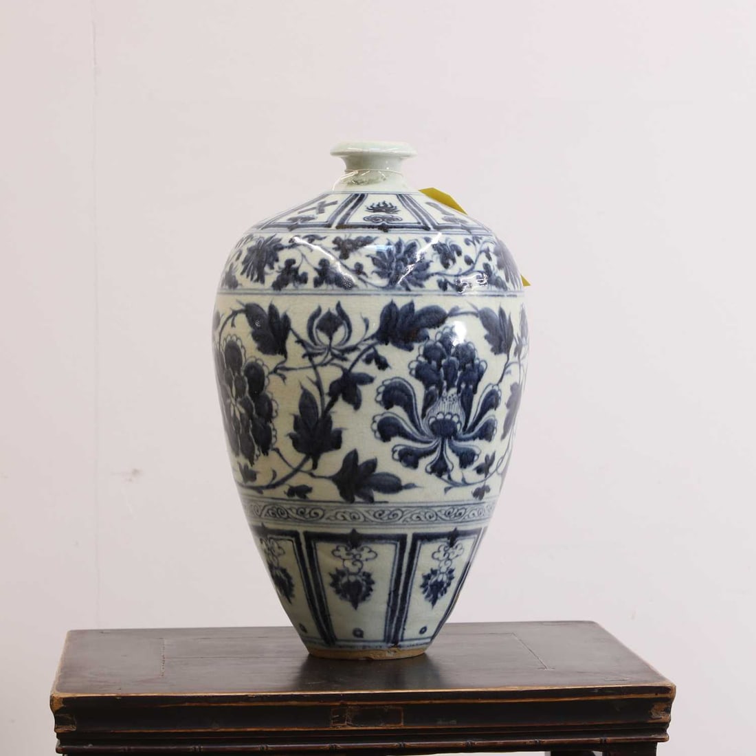 A Chinese blue and white meiping vase, 20th century,: A Chinese blue and white meiping vase, 20th century, painted in underglaze blue with banded decoration of scrolling lotus and trailing vines 23cm wide, 38cm high Condition Report: A large amount of