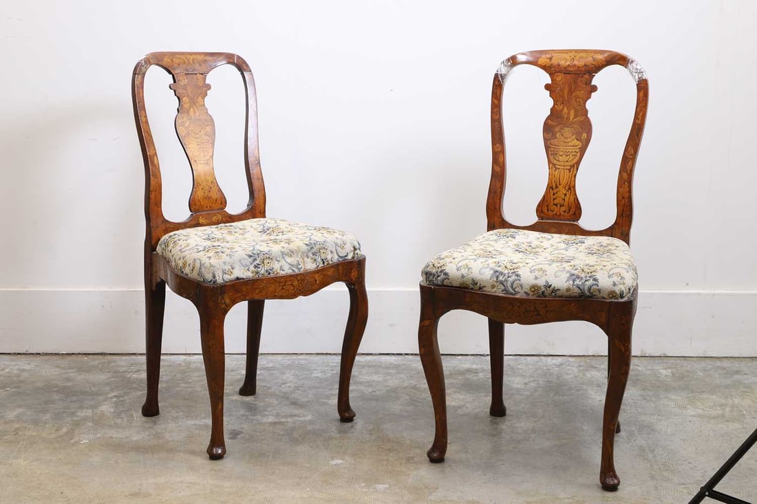 A pair of Dutch walnut and marquetry inlaid chairs, late 18th century,: A pair of Dutch walnut and marquetry inlaid chairs, late 18th century, with drop-in seats upholstered in floral fabric 52cm wide, 43cm deep, 98cm high 2