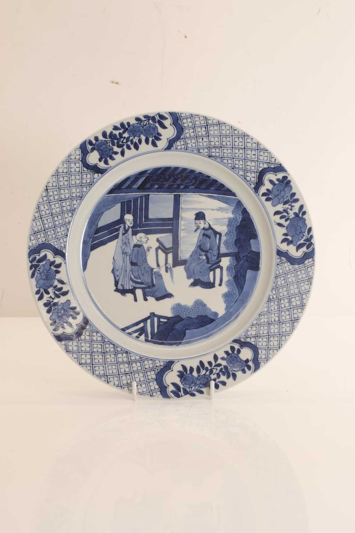 A Chinese blue and white dish,: A Chinese blue and white dish, the centre painted with three Buddhist monks in an interior, enclosed by a diapered border 26.5cm diameter
