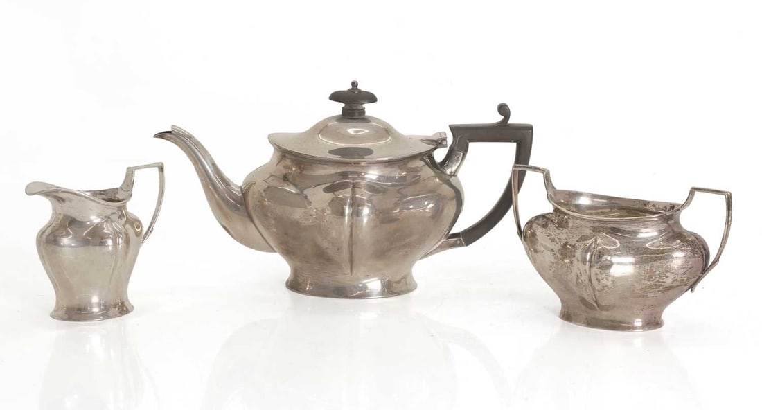 A silver three piece tea set, by Henry Stratford Ltd, Sheffield, 1910: A silver three piece tea set, by Henry Stratford Ltd, Sheffield, 1910 in the Art Nouveau taste, teapot, 13.5cm high, 15.7ozt 3 Condition Report: Marks fair, tarnishing. Dent to the body of the teapot.