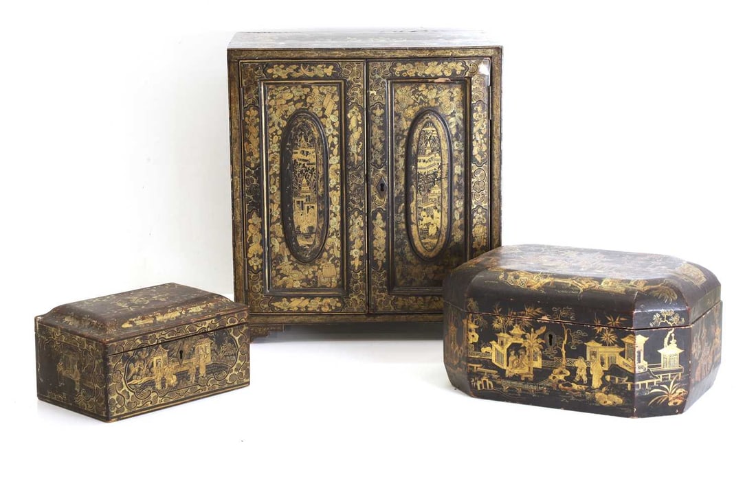 Three black Japanned chinoiserie items, late 19th century,: Three black Japanned chinoiserie items, late 19th century, comprising two tea caddies and a table cabinet, enclosing five drawers tea caddies, 19.5cm wide, 17.5cm wide, cabinet, 32cm wide, 18cm deep,