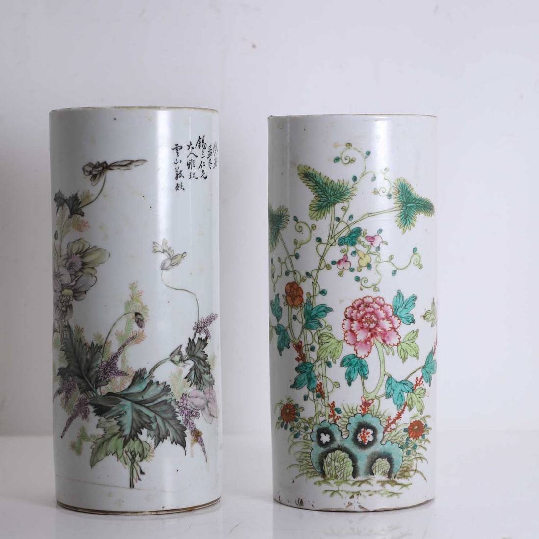 A Chinese porcelain sleeve vase, circa 1900,: A Chinese porcelain sleeve vase, circa 1900, painted with flowering foliage, an inscription to the reverse, together with a Chinese famille verte sleeve vase, circa 1900, painted with peonies and foli