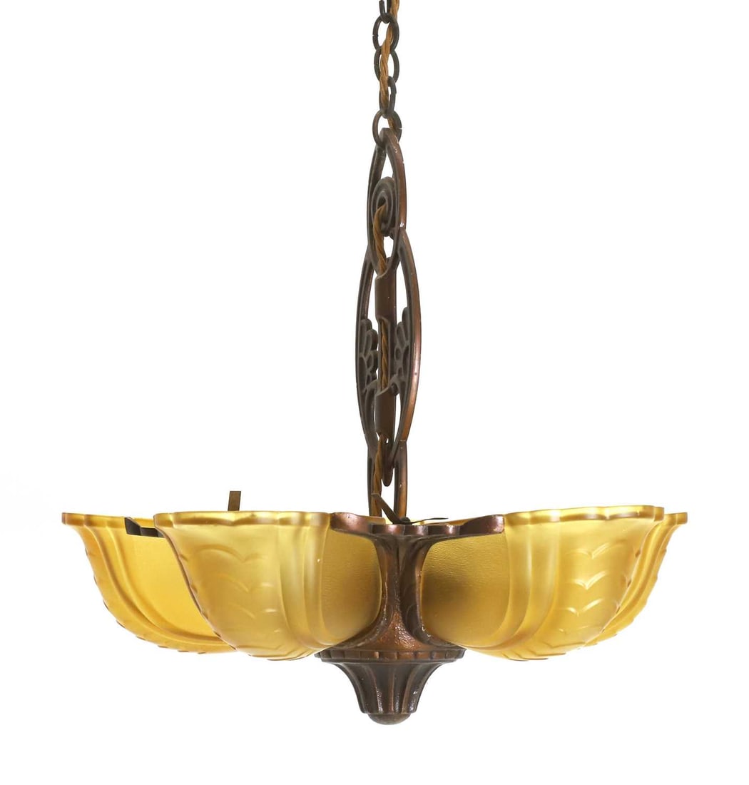 An art deco ceiling light fitting, 20th century,: An art deco ceiling light fitting, 20th century, with yellow glass shades shaped with scales, and the central column with floral motifs 33cm wide, 39cm high