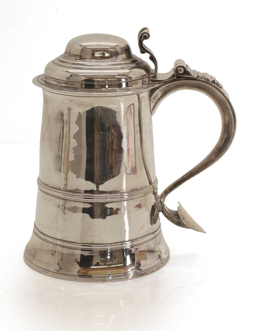 A George III silver tankard,: A George III silver tankard, by Thomas Wallis I, London, 1773, with shaped thumb piece, the scroll handle terminating with a heart shaped motif 19cm wide, 21cm high, 27.5ozt Condition Report: Some