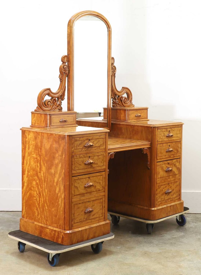 A Victorian satin birch dressing table, late 19th century,: A Victorian satin birch dressing table, late 19th century, fitted with an arched mirror, and an arrangement of eight drawers with drop central desk top 135cm wide, 53cm deep, 177cm high 4