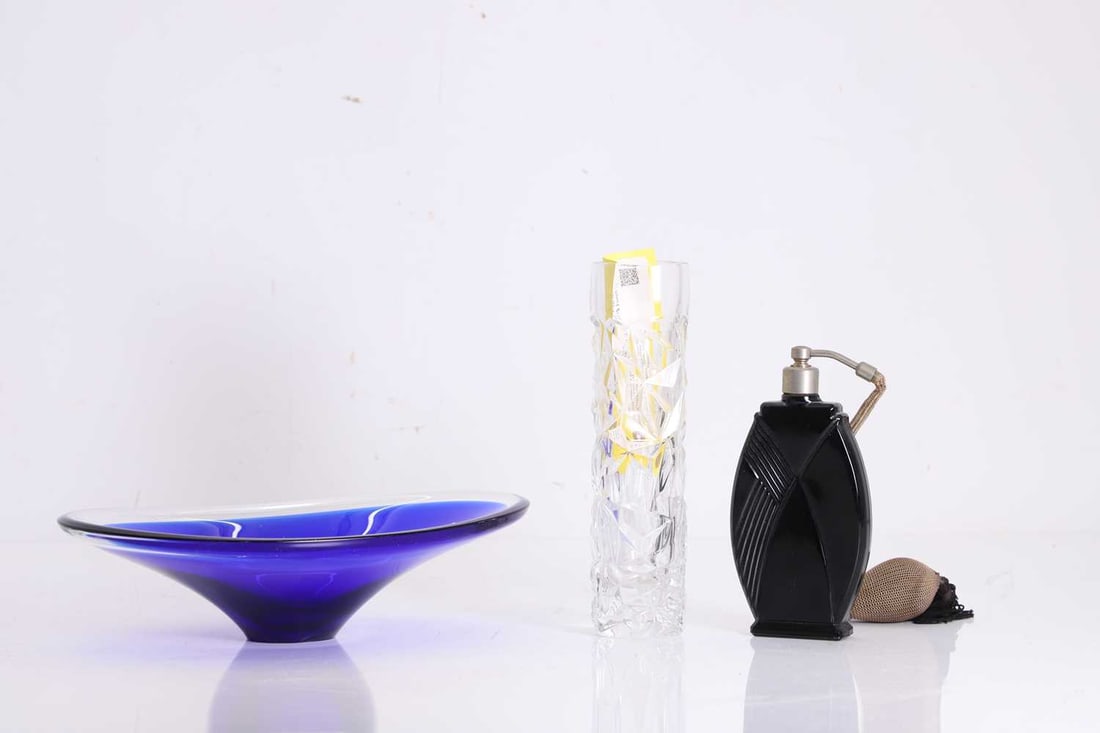 A collection of glass items, 20th century,: A collection of glass items, 20th century, comprising a Murano-type bowl, cased in clear over blue, a Tiffany & Co cut glass vase, acid marked, and a French 'black' glass scent bottle, with
