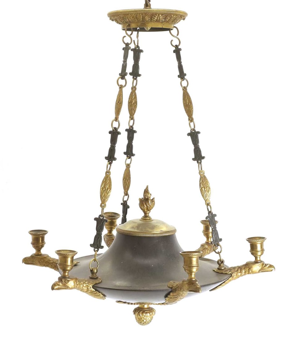 A French Empire revival ormolu chandelier,: A French Empire revival ormolu chandelier, each of the six branches shaped as an eagle head and flame surmounts the main body 47cm wide Condition Report: A large collection of dust and dirt. Marks