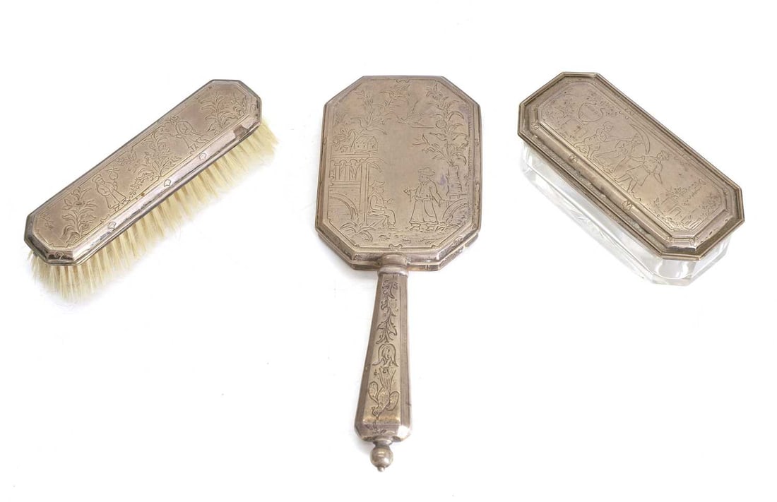 a silver dressing table set,: a silver dressing table set, by D & J Wellby Ltd, London, 1921, to include a mirror, cut glass powder pot and brush, all with engraved or stamped with chinese style scenes, 26cm long, 20.2ozt