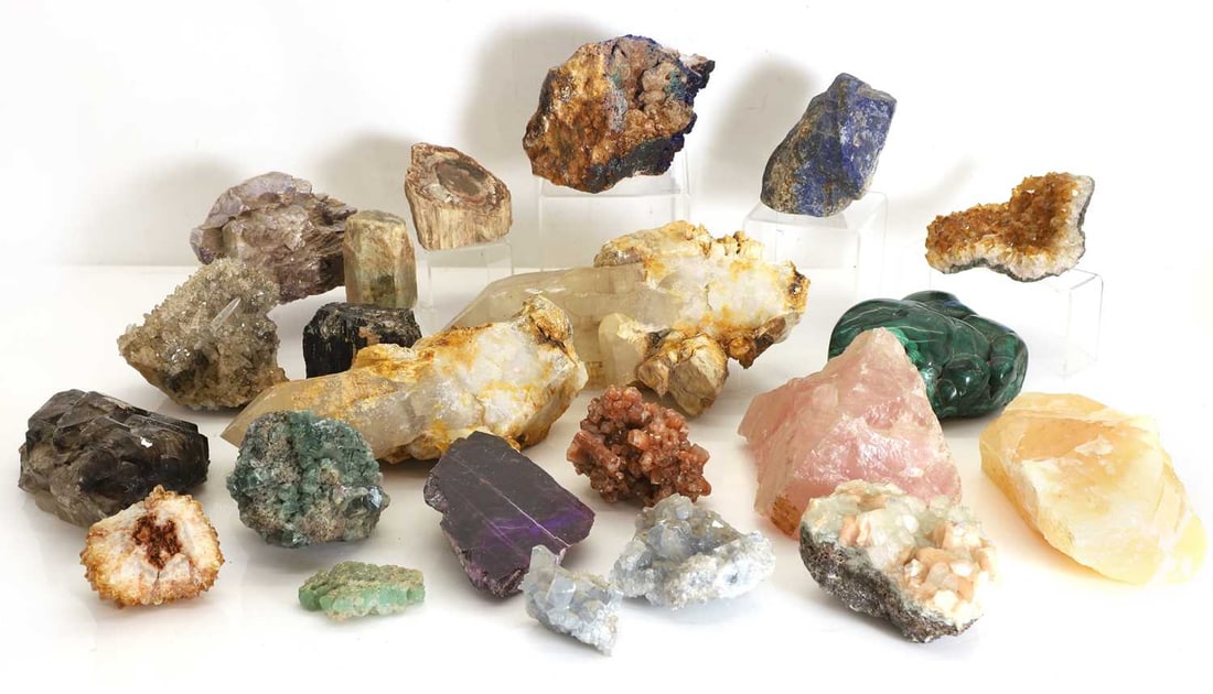 A collection of semi precious stone and petrified wood fragments: A collection of semi precious stone and petrified wood fragments to include malachite, smoky quartz, chrysophrase, and beryl largest 30cm wide (qty.)
