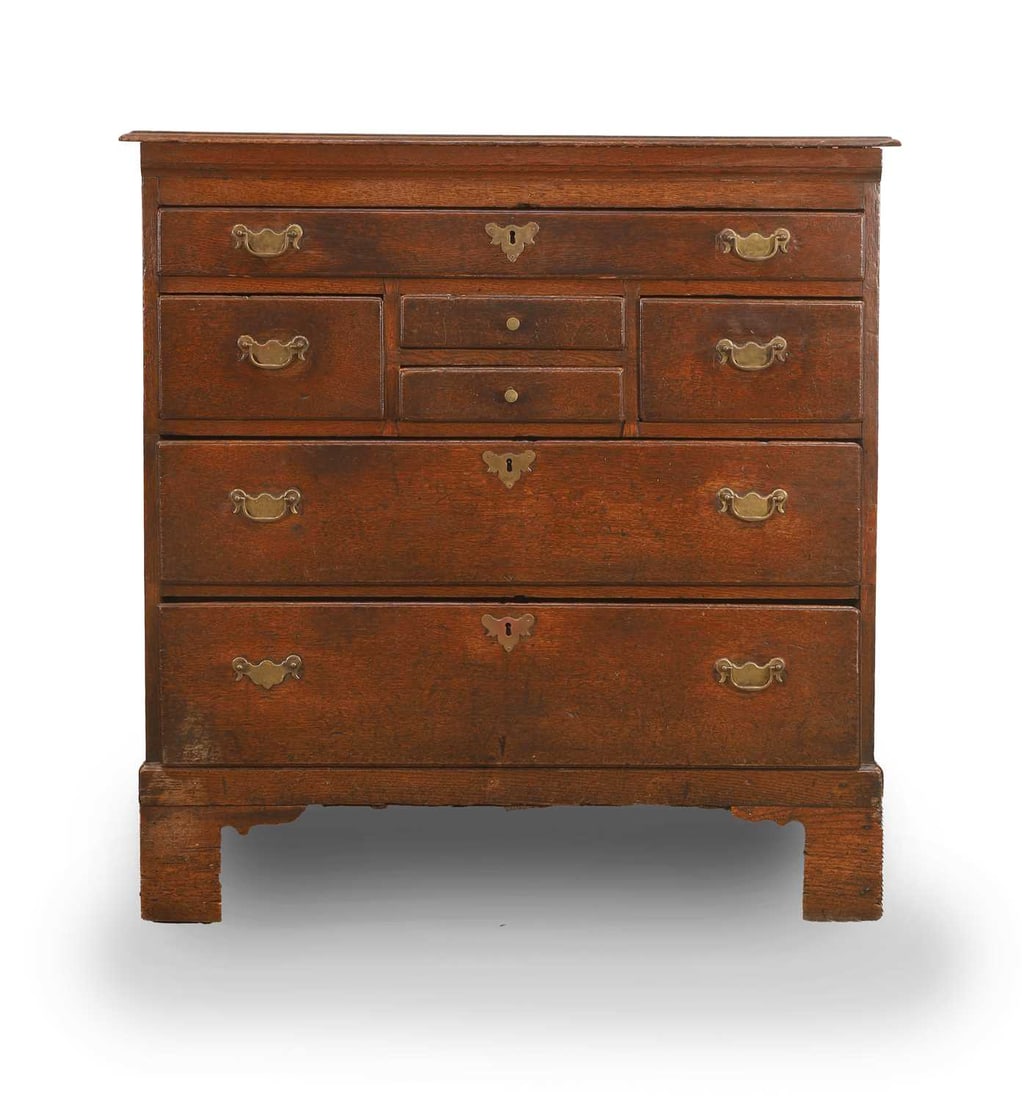 An oak chest of drawers, 19th century,: An oak chest of drawers, 19th century, with an arrangement of seven drawers, on bracket feet 91cm wide, 51cm deep, 95.5cm high