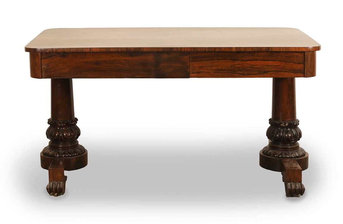 A mahogany sofa table, 19th century,: A mahogany sofa table, 19th century, in the manner of Gillows, the curved rectangular top above two frieze drawers, and apposing dummy drawers, raised on turned and carved column supports,