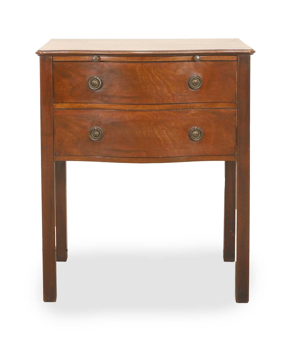 A George III style mahogany bedside chest,: A George III style mahogany bedside chest, the serpentine front top above a brushing slide and two graduated drawers fitted with brass ring handles, raised on square legs 61cm wide, 43.5cm deep, 74cm