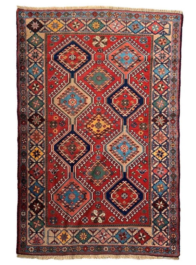 A Persian Yalameh rug, 20th century,: A Persian Yalameh rug, 20th century, woven with repeating geometric motifs to a red ground 148 x 99cm
