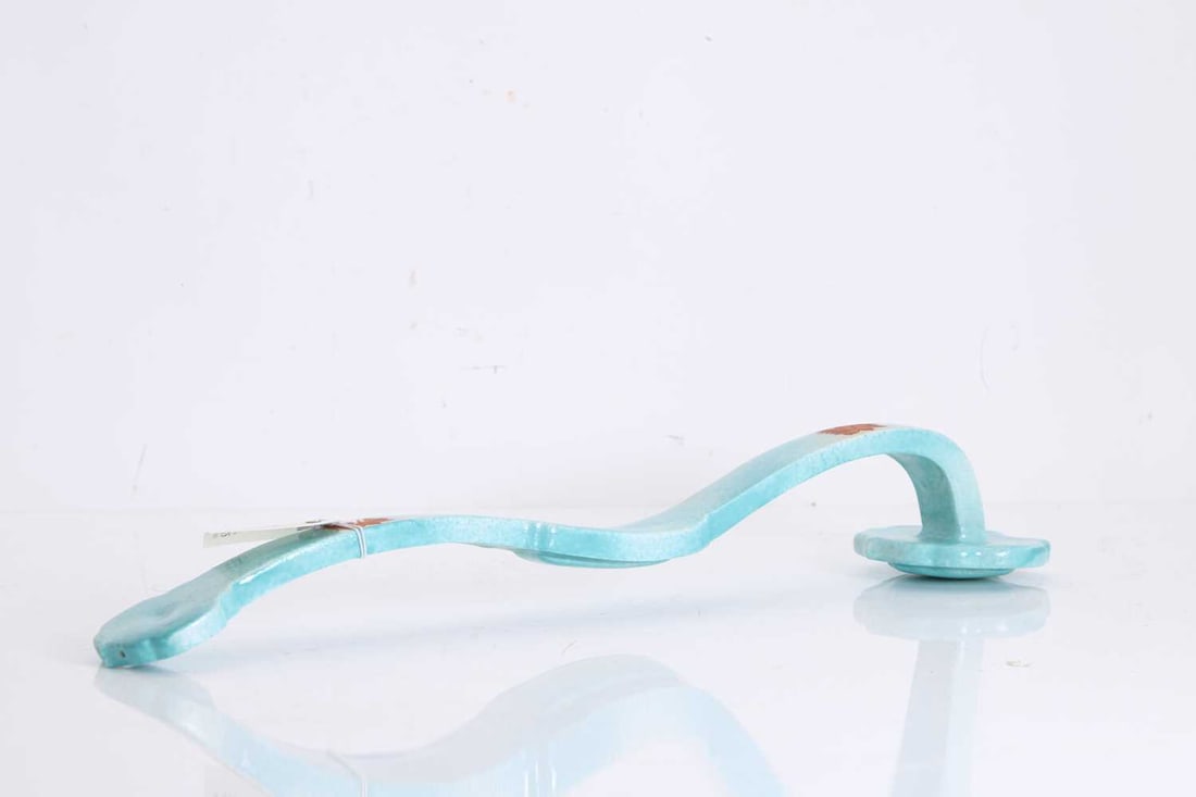 A large ruyi septer: A large ruyi septer of typical form, the body with a turquoise mottled ground, each end decorated with a stylised lotus 48cm long Condition Report: in fair overall condition, areas of overpaint on