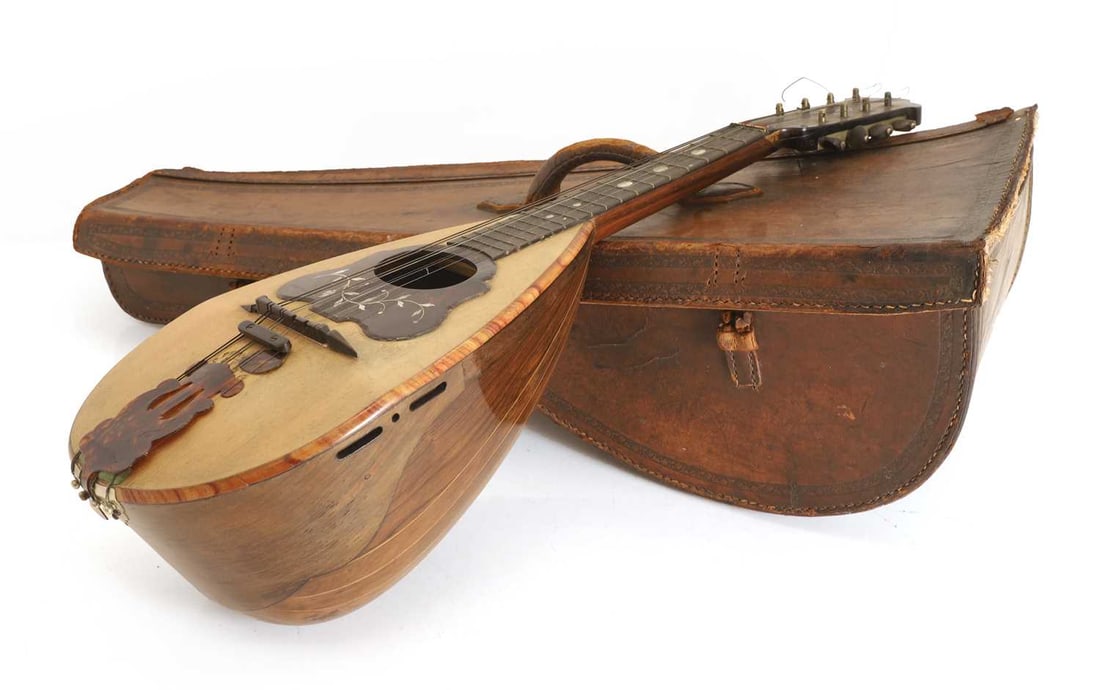 A Giovanni de Maglio model 1A mandolin, early 20th century, Italian,: A Giovanni de Maglio model 1A mandolin, early 20th century, Italian, the front with mounted tortoiseshell and mother of pearl, decoration in a leather case Shipping Disclaimer: Buyers must be aware