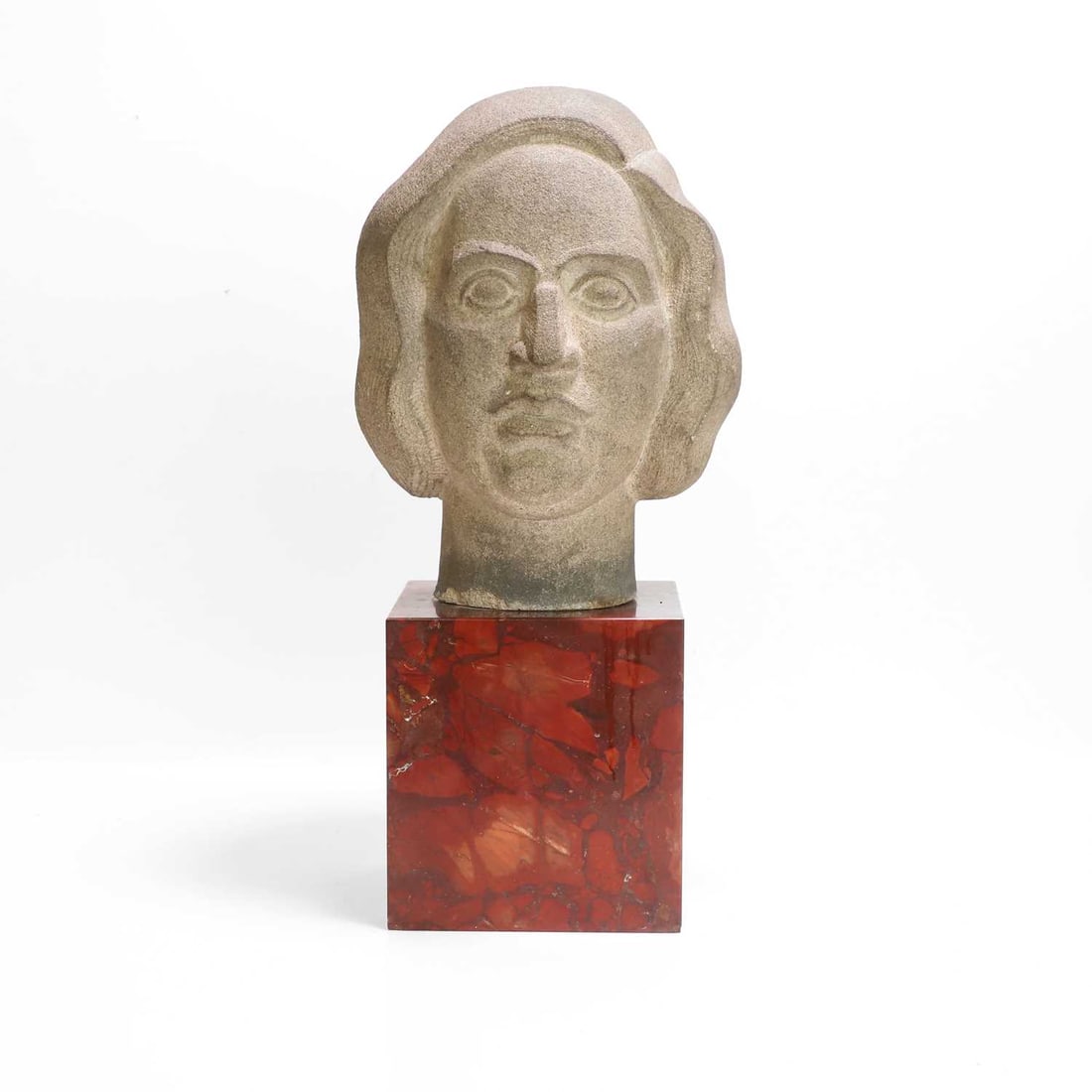 Manner of Eric Gill, a stone carved head,: Manner of Eric Gill, a stone carved head, of recent manufacture, depicting a female, raised on a red marble plinth 31cm wide, 10.5cm deep, 22cm high 2