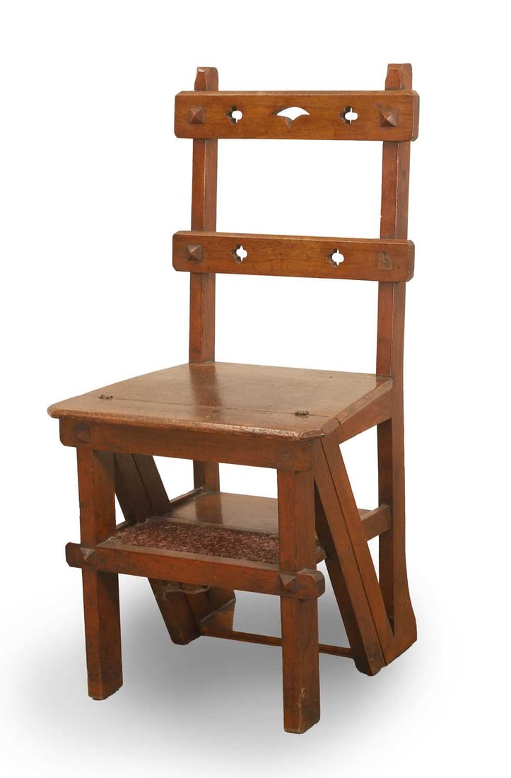 A late Victorian oak metamorphic library chair, late 19th to early 20th century,: A late Victorian oak metamorphic library chair, late 19th to early 20th century, in the Gothic revival taste, the back with pierced quatrefoil and lozenge ornament above a hinged seat, transforming