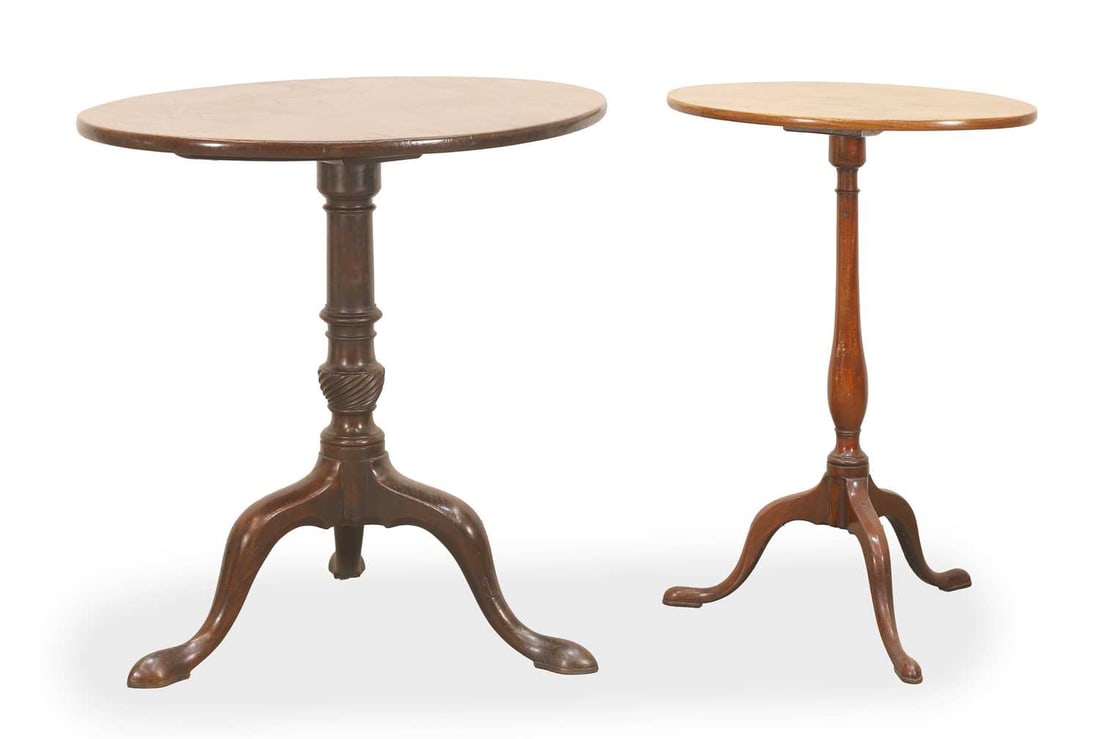 Two mahogany tilt-top occasional tables,: Two mahogany tilt-top occasional tables, both of oval/circular form, with carved central column terminating in a tripod base The largest, 73cm diameter, 73cm high 2