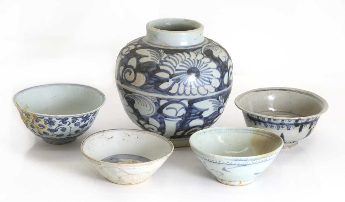 Four provincial Chinese bowls, 19th century,: Four provincial Chinese bowls, 19th century, with blue and white decoration, each with foliate design, and one with stylisitic mark to the base, together with a similar style vase of baulster form