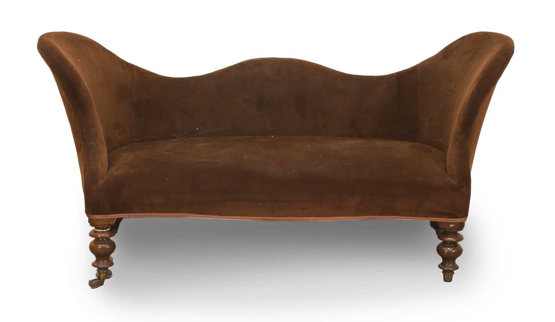 A Victorian salon settee,: A Victorian salon settee, covered in brown velvet upholstery, the serpentine back and outswept arms above a bow fronted seat, raised on bulbous turned walnut legs and castors 166cm wide,60cm deep,