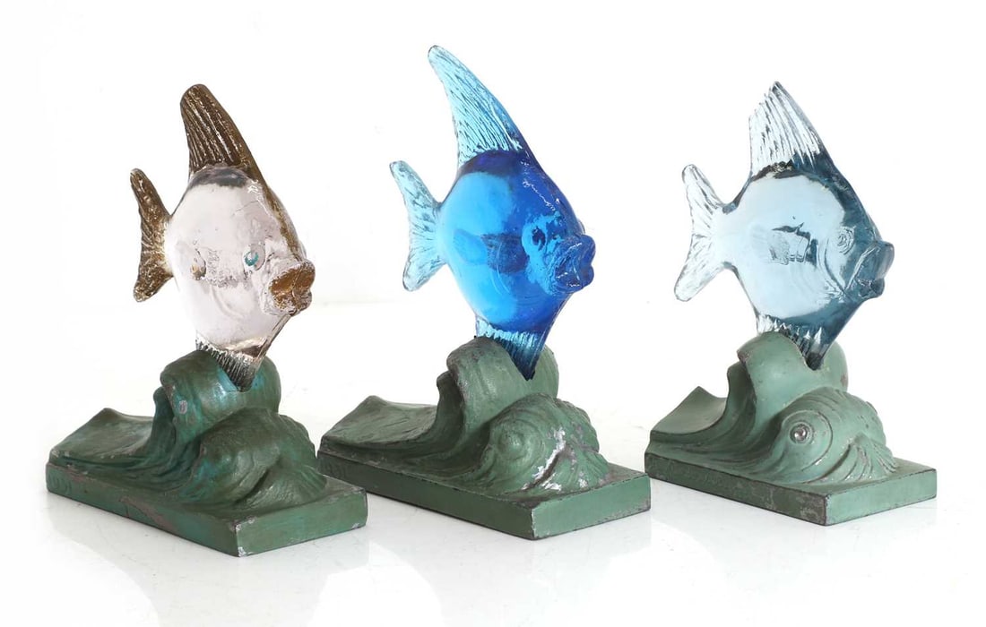 A set of three Art Deco glass and spelter paperweights, 1930s,: A set of three Art Deco glass and spelter paperweights, 1930s, each in the form of a fish within waves, designed by Guy Underwood, two signed and dated 1931, one with signed and dated 1935 largest