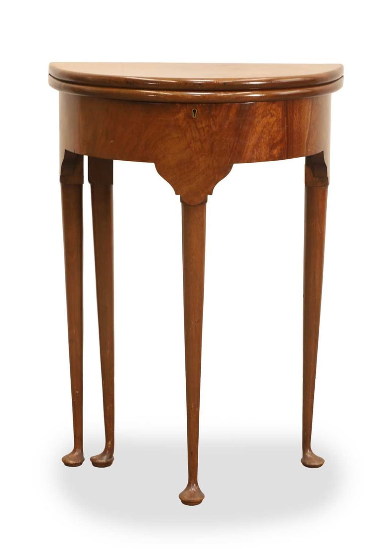 A mahogany small demi lune table, 20th century,: A mahogany small demi lune table, 20th century, with gate leg action, and shaped frieze opening to reveal a lower compartment, terminating in pad feet 51cm diameter, 25cm deep, 72cm high