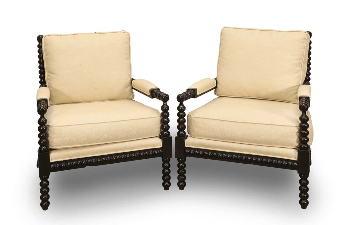 A pair of contemporary ebonised bobbin turned chairs, of recent manufacture,: A pair of contemporary ebonised bobbin turned chairs, of recent manufacture, the frame with bobbin turned ornament and outswept arms, upholstered in a cream woven fabric with loose cushion, with