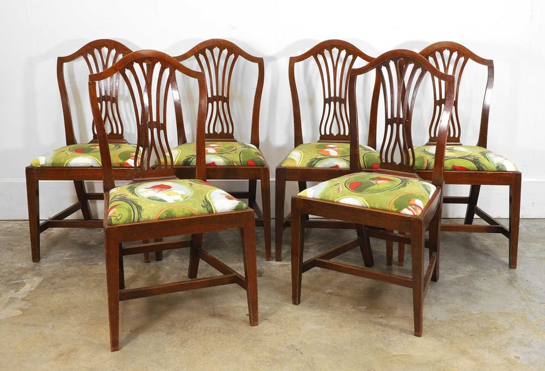 A set of six mahogany Hepplewhite style dining chairs, 19th century,: A set of six mahogany Hepplewhite style dining chairs, 19th century, the serpentine top rail over pierced vase splat, with jockey print upholstered drop-in seats 51cm wide, 48cm deep, 97cm high 6