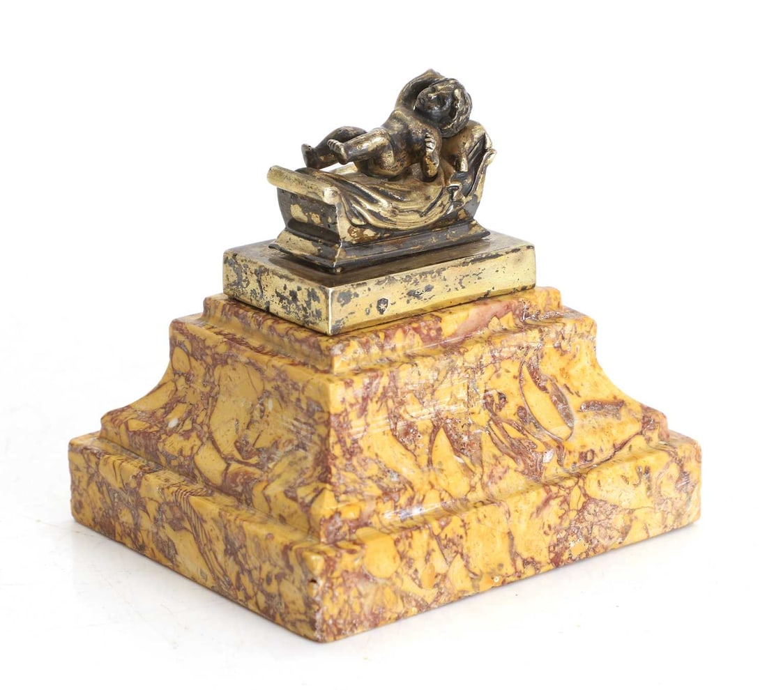 A marble and silver desk weight,: A marble and silver desk weight, possibly after The Birth of the King of Rome, stamped with an Italian hallmark, on a Siena marble base 9.7cm wide, 9.5cm high Condition Report: Some looseness to then 