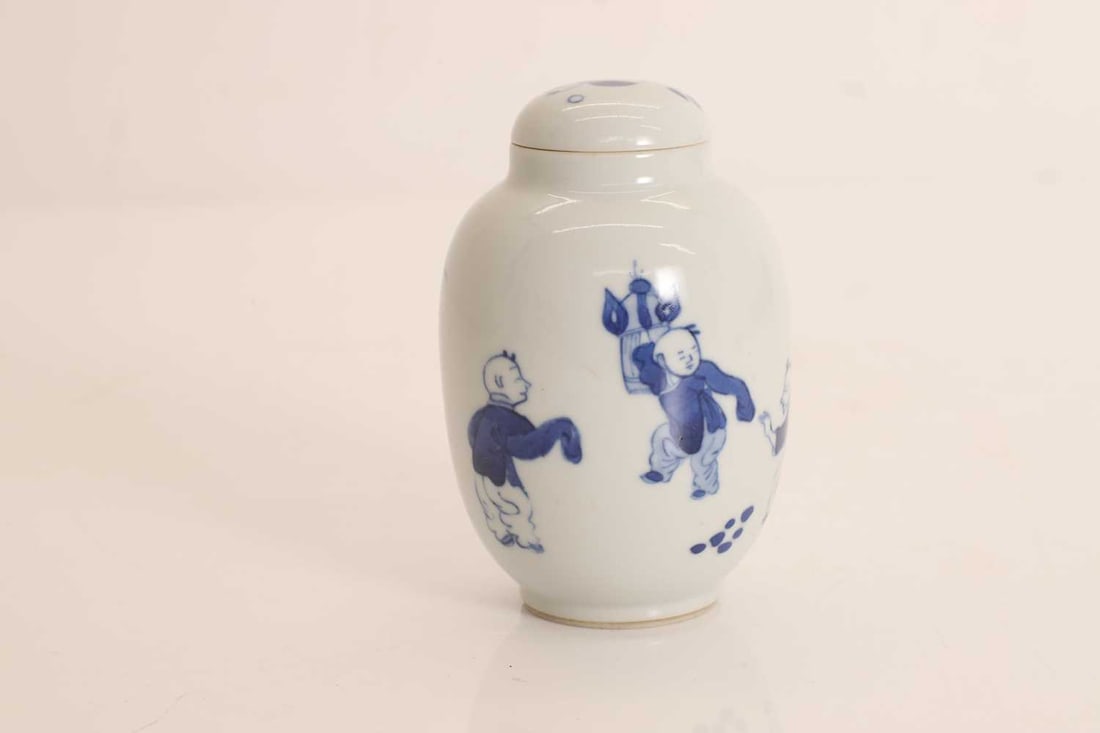 A Chinese blue and white tea caddy, 20th century,: A Chinese blue and white tea caddy, 20th century, painted with boys and rockery 7cm wide, 11cm high Condition Report: Some minor pitting and some glazing faults. Overall good