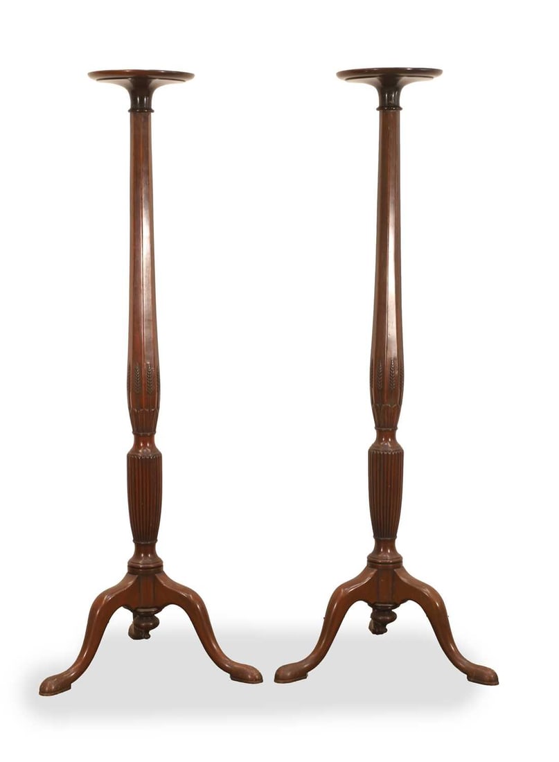 A pair of mahogany torchere stands, 19th century,: A pair of mahogany torchere stands, 19th century, with wheatsheaf carved columns on triform bases together with a 19th century column standard lamp, The largest 152cm