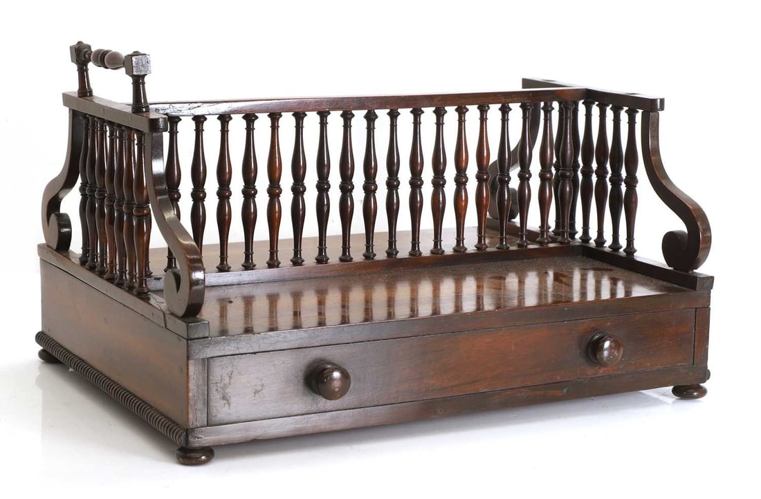 A Regency rosewood double sided book trough, 19th century,: A Regency rosewood double sided book trough, 19th century, with a turned spindle gallery and handles over a frieze drawer and dummy drawer 41cm wide, 34cm deep, 26cm high