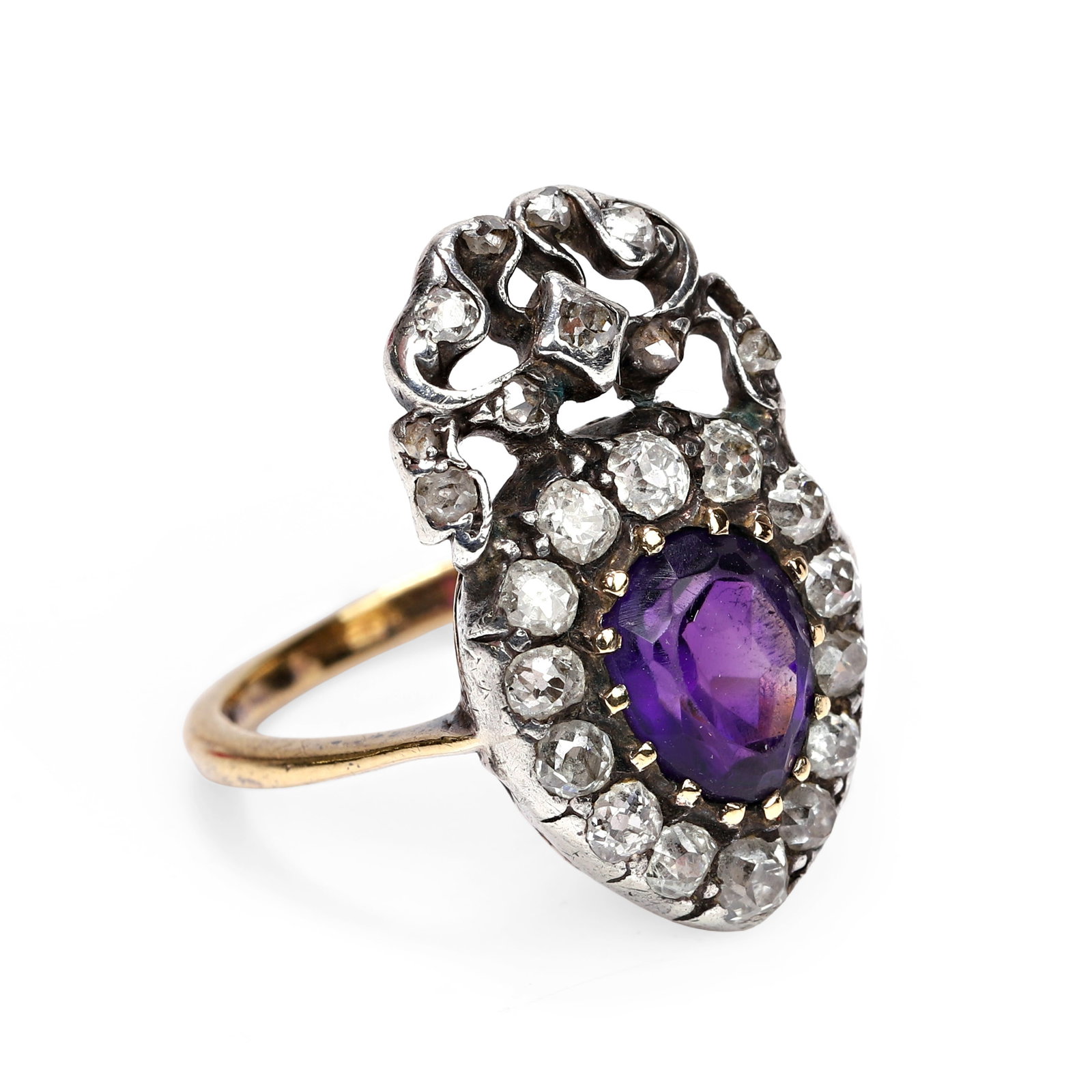 A Victorian amethyst and diamond ring,: A Victorian amethyst and diamond ring, the heart and ribbon bow motif claw set to the centre with a pear cut amethyst, to a surround of old cut diamonds, the bow atop set with eight cut, old cut and r