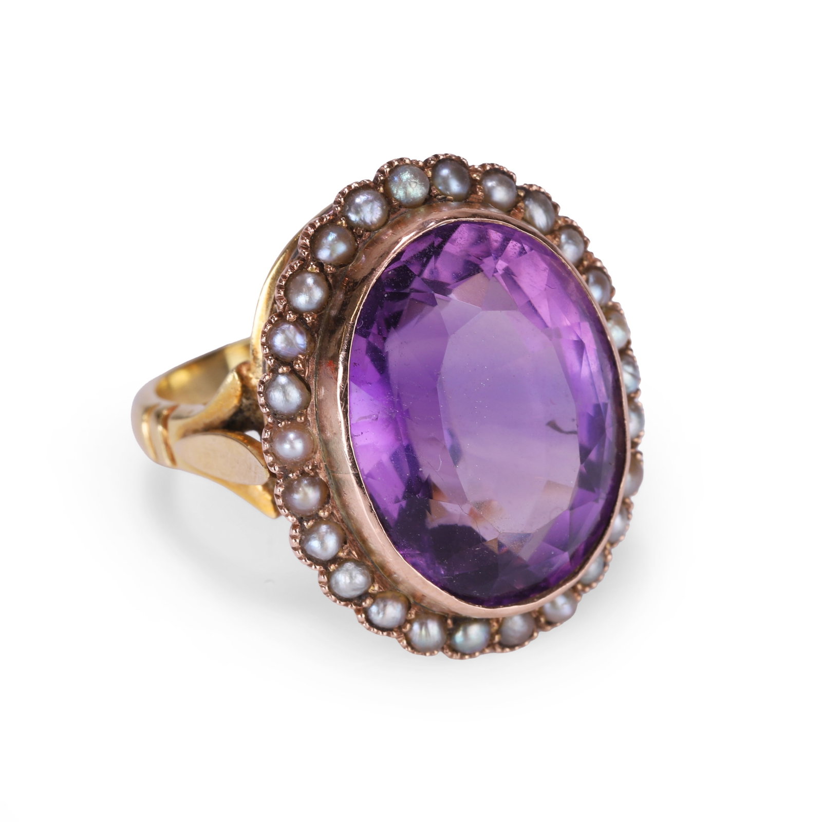 An amethyst and split pearl cluster ring,: An amethyst and split pearl cluster ring, the central faceted oval amethyst, rub over set and surrounded by a halo of split pearls with millegrain edging and scalloped mount detailing, stamped 18ct an