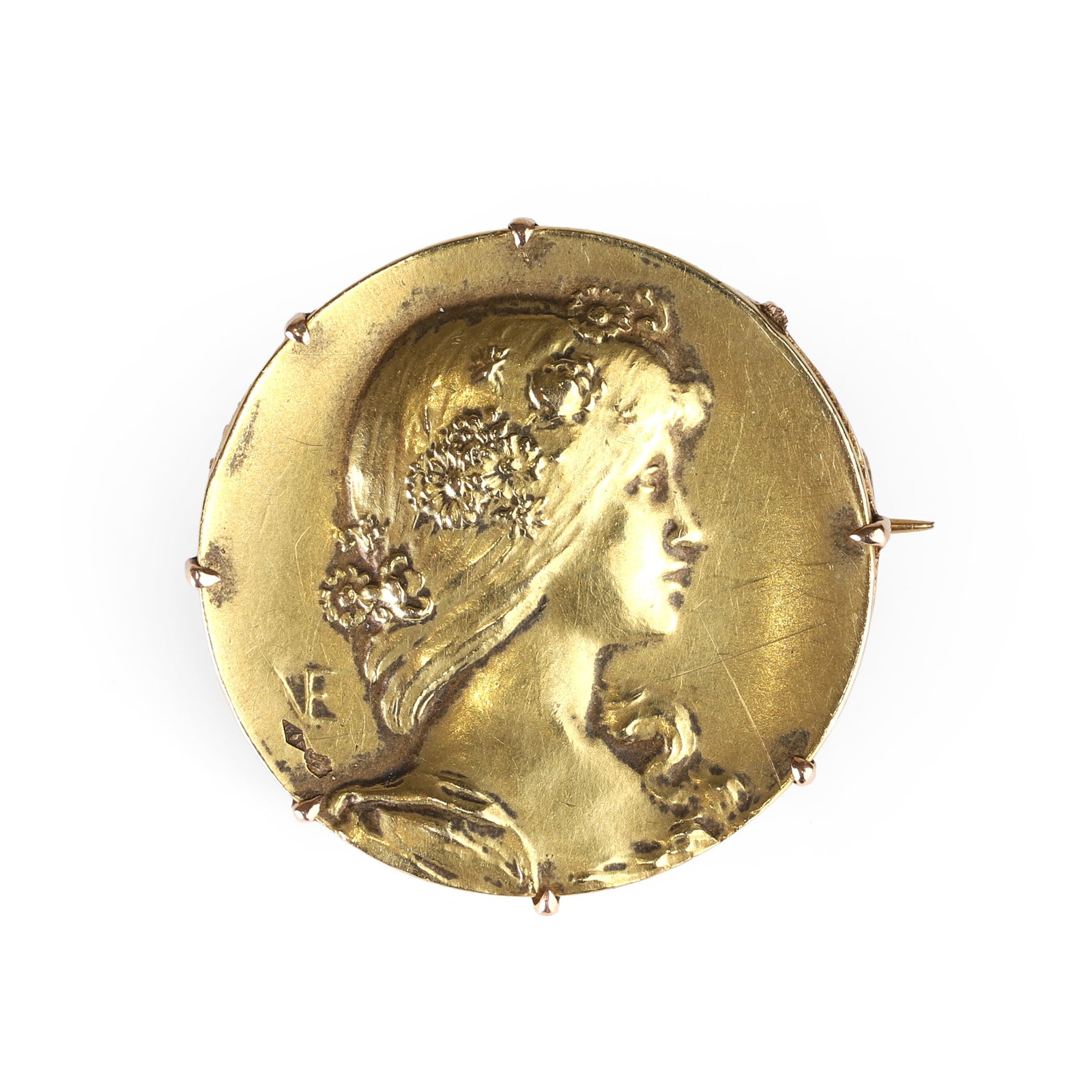 A French Art Nouveau gold brooch, by Emile Vernier, circa 1900,: A French Art Nouveau gold brooch, by Emile Vernier, circa 1900, of circular form, depicting a young female in profile, the hair adorned with flowers, signed with monogram VE, boar's head poinçon 